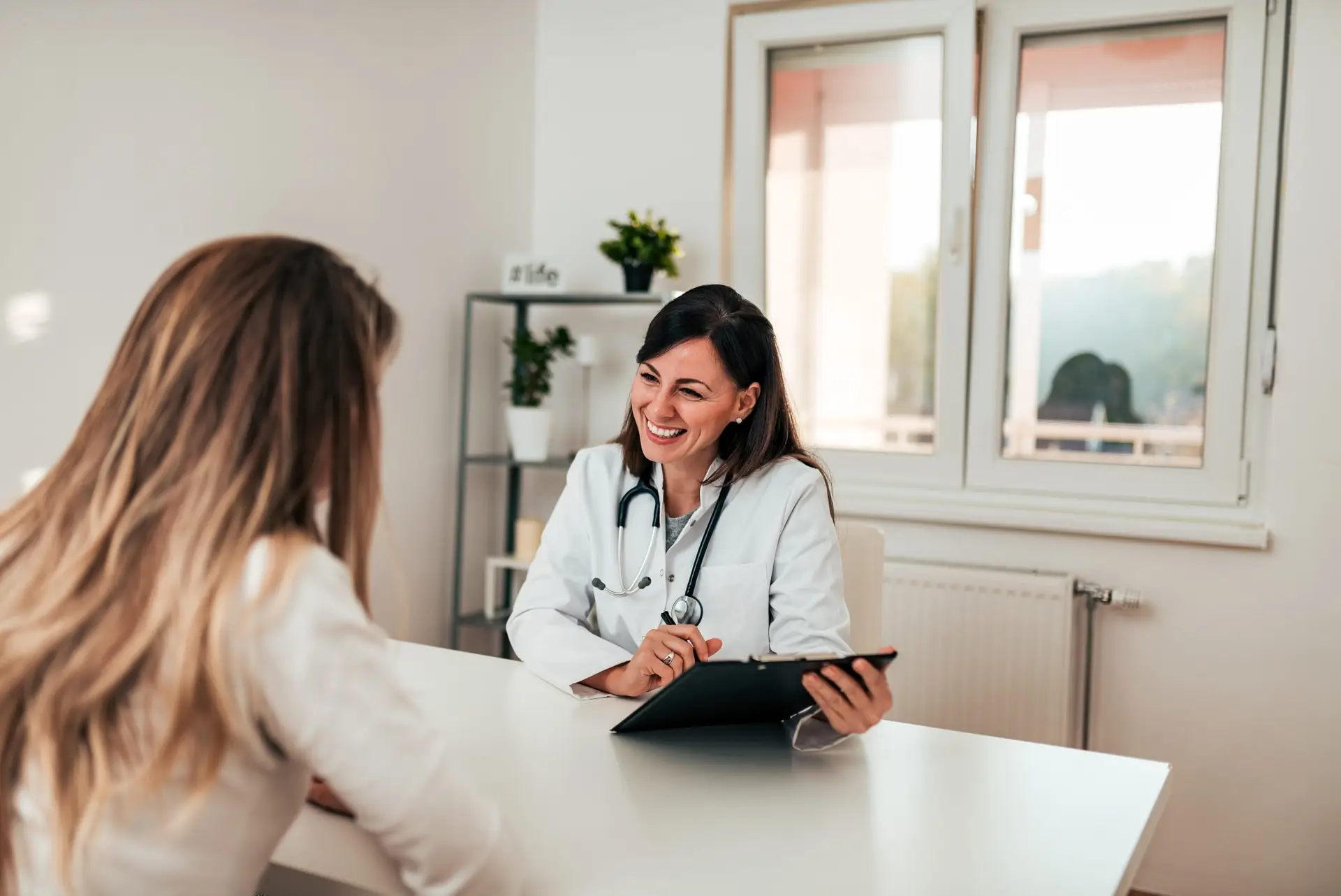 Beautiful female specialist talking to her patient.